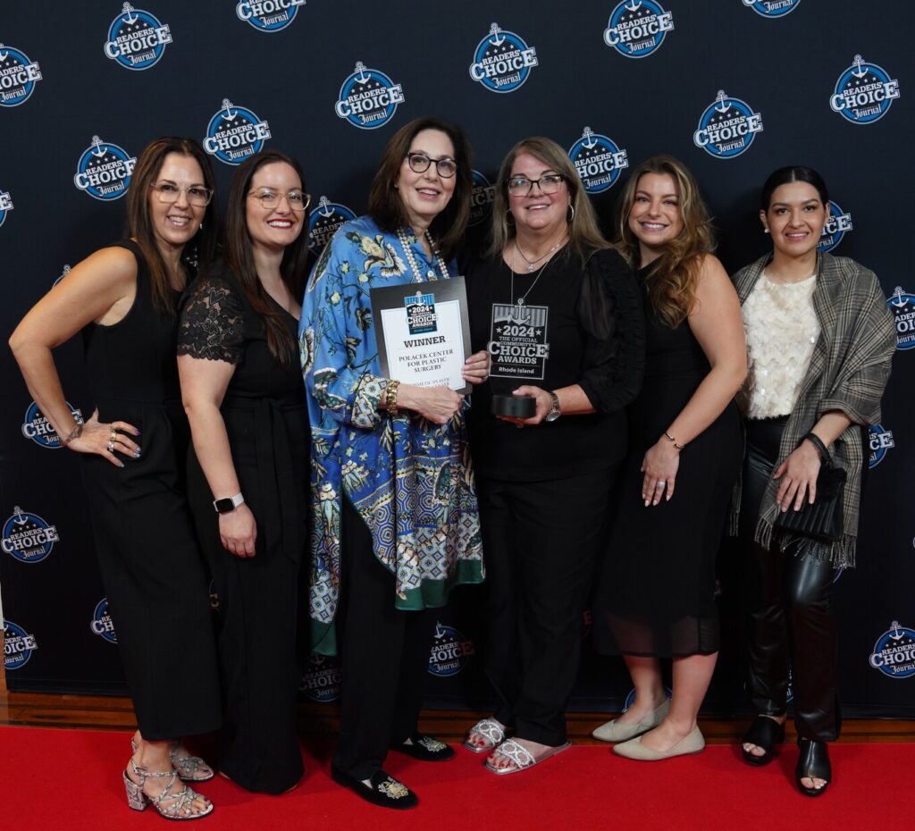 group photo of the staff with Dr. Polacek holding the 2024 Rhode Island Community's Choice Award 